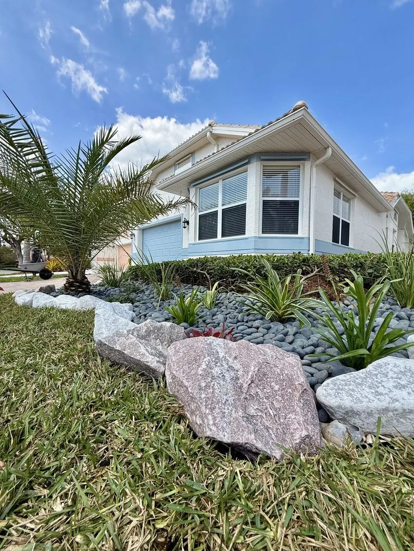 River-rock bed with boulders and plantings